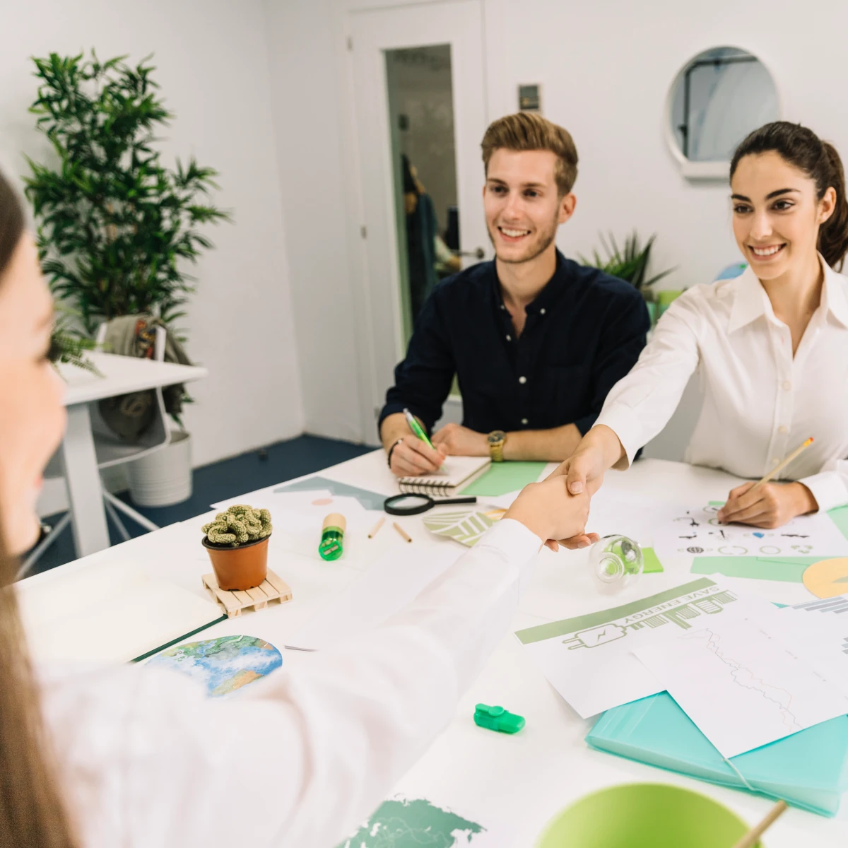 two happy businesswomen shake hands during a business meeting